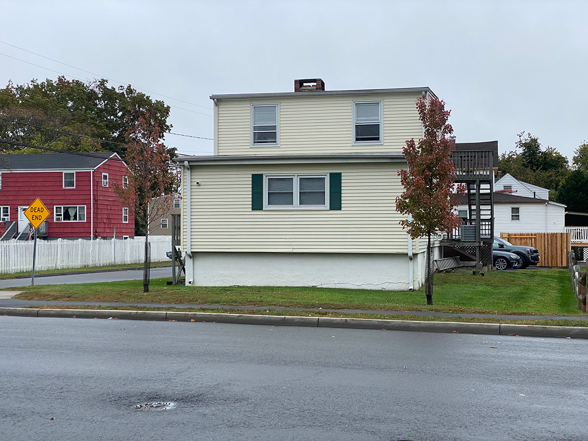 A house with trees in front of it. 