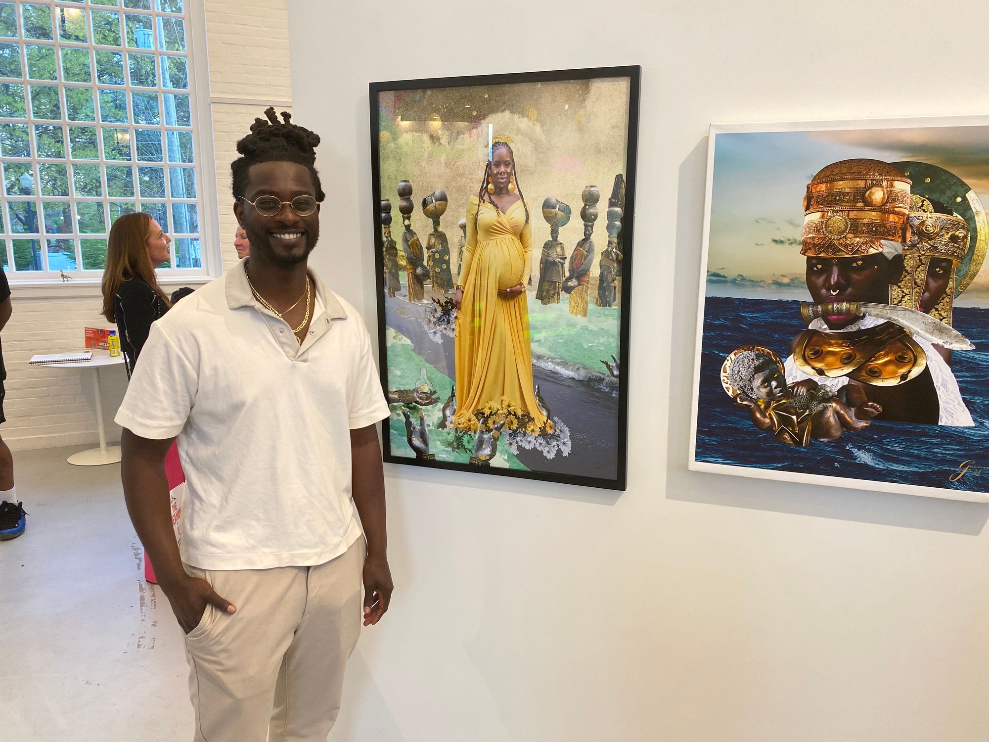 A man poses in front of a photo